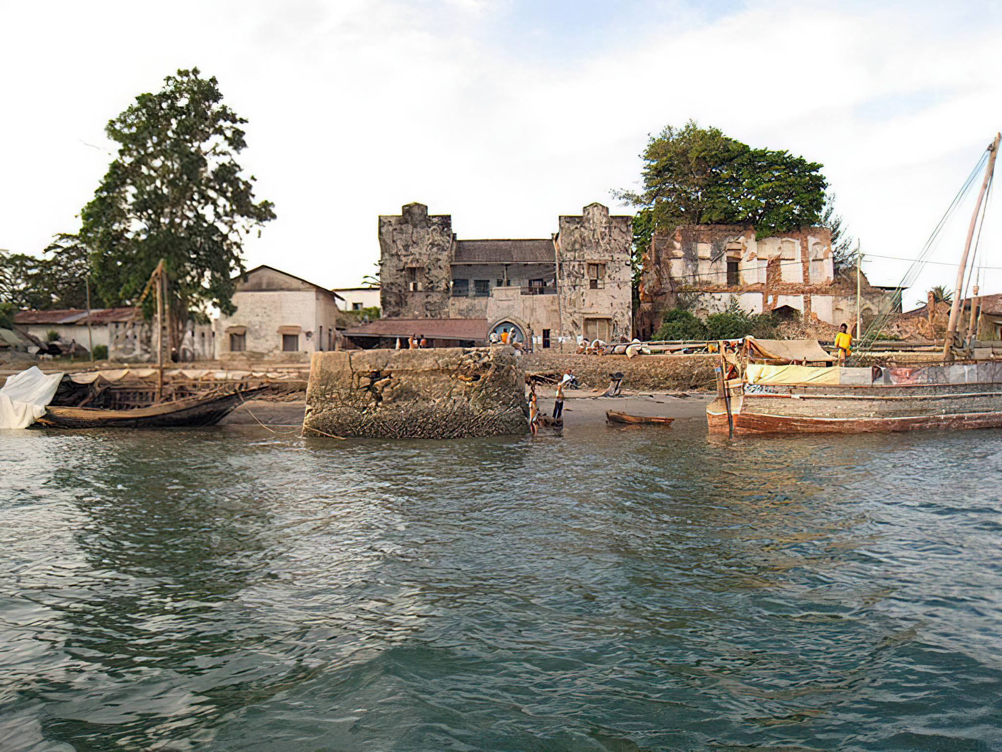 Country: Tanzania
Site: Pangani Historic Town
Caption: From the water: German-built Customs House, centre (behind the jetty pillar), with the Old Ibadhi Mosque on its left and the Al-Kasaby House on its right.  
Image Date: 22 March 2009
Photographer: Jeremy Cross
Provenance: 2010 Watch Nomination
Original: from Share File